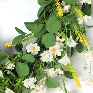 Macro detail of artificial white daisies and eucalyptus leaves for home wall decor