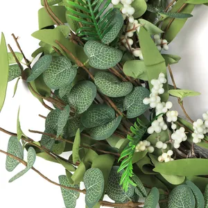 Detailed close-up of realistic eucalyptus leaves and white berries on the decorative wreath