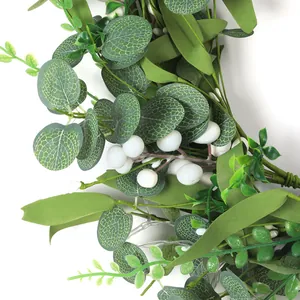 Detailed close-up of eucalyptus leaves and white berries on an LED lighted garland