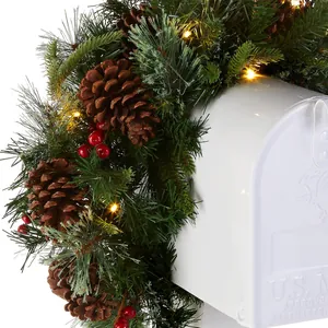LED Christmas pine cone wreath with red berries wrapped on a white mailbox decoration