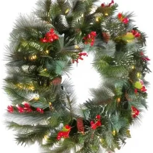 Christmas wreath with artificial pine needles, red berries, pine cones and warm LED lights