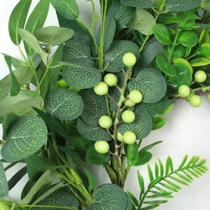 Macro shot of faux eucalyptus leaves with white veins and green berries for home decor