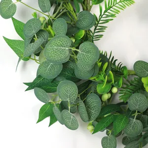 Detailed close-up of eucalyptus leaves and green berries on a lush artificial wreath