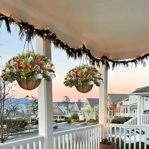 Outdoor Christmas hanging baskets with pine needles red berries pinecones and LED lights