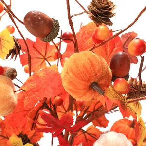Autumn harvest branch with velvet pumpkin, maple leaves, pine cones, and acorns