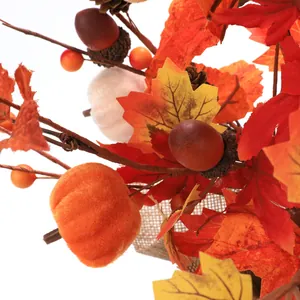 Autumn velvet pumpkin branch with maple leaves, acorns and pinecones for harvest decor