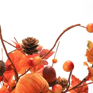 Detailed view of Thanksgiving decor with velvet pumpkins, acorns, and maple leaves