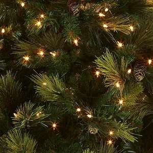 Green 2.1m PVC Christmas tree with warm LED lights and decorative pine cones
