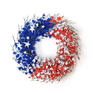 Patriotic 4th of July wreath with red white blue flowers and stars on rustic twig base