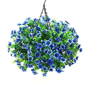 Close-up of artificial blue flowers with green leaves in a hanging coconut fiber basket