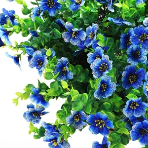 Macro shot of faux blue flowers with detailed petals and vibrant yellow stamens