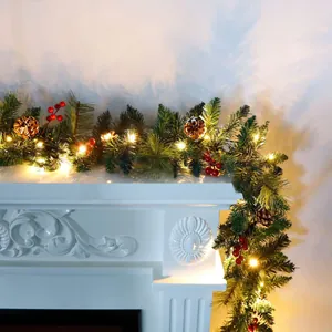 Illuminated Christmas garland with pine cones and red berries on a white fireplace mantel