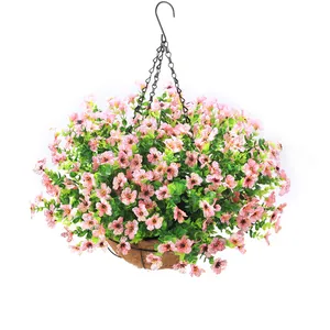 Hanging basket with pink artificial flowers and lush green leaves on black metal chains