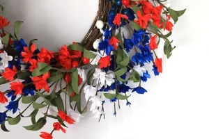 Macro detail of red white and blue artificial flowers on natural vine wreath base
