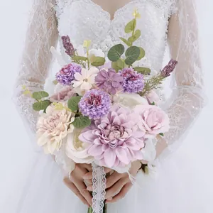 Bride holding a purple and ivory faux wedding bouquet with lace ribbon detail
