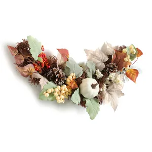 Autumn harvest wreath with white pumpkins, maple leaves, and pine cones on white background