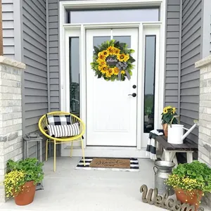 Front door welcome wreath featuring yellow sunflowers and a black and white buffalo plaid bow