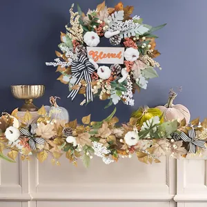 Detail of autumn wreath and vine with white pumpkins, maple leaves and Blessed sign