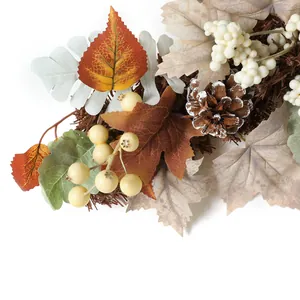 Autumn harvest wreath with maple leaves pinecones and white berries for wall decor