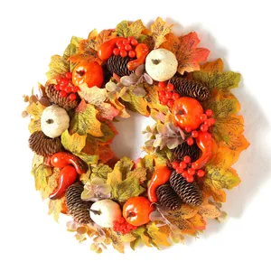 Autumn wreath with pumpkins, pine cones and maple leaves for Thanksgiving door decoration