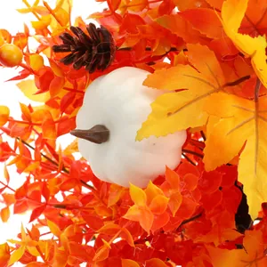 Artificial autumn lavender with white pumpkin, orange maple leaves, and pine cones