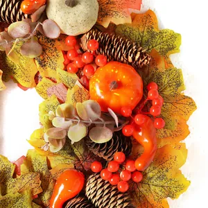 Fall wreath with maple leaves, pumpkins, and pine cones for Thanksgiving door decor