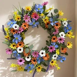 Artificial spring daisy wreath with colorful flowers and green leaves for home wall decor