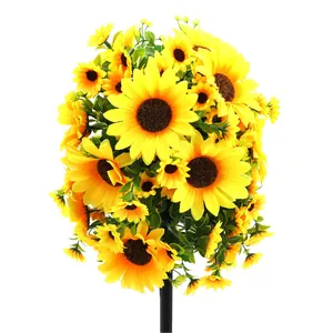 Artificial sunflower bouquet with vibrant yellow petals and green leaves on white background