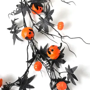 Halloween pumpkin vine with black maple leaves and orange jack-o-lantern decorations