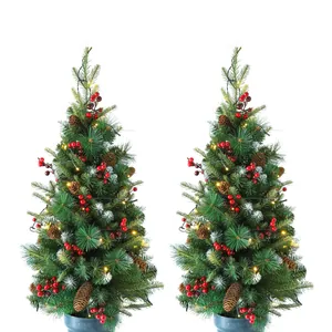 Two 90cm artificial Christmas trees with red berries, pinecones and warm LED lights
