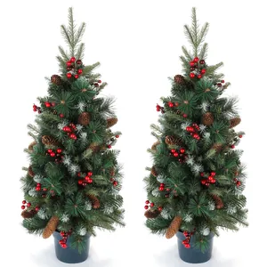 Detail of 90cm artificial Christmas trees with red berries, pine cones and snow frost