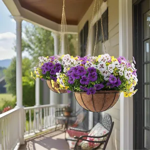 Hanging basket with purple, white, and yellow pansies on a sunny porch with metal chains