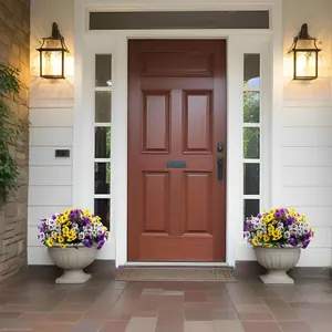 Classic dark brown wooden entry door flanked by vibrant purple and yellow pansy flowers