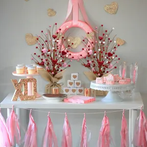Close-up of Valentine's berry tree with red hearts, burlap base and gold XO decor