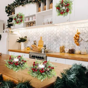 Détail de couronnes de bougies de Noël avec baies rouges et pommes de pin décor