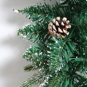 Christmas pine garland with snow flocked needles and natural pinecone festive decoration