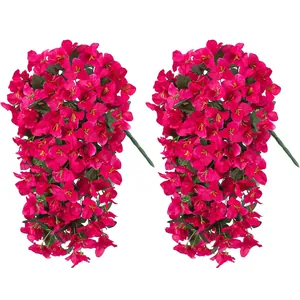 Detail of two hanging magenta bougainvillea artificial flower stems with green leaves