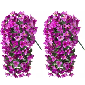 Close-up of two artificial purple bougainvillea hanging plants with green leaves