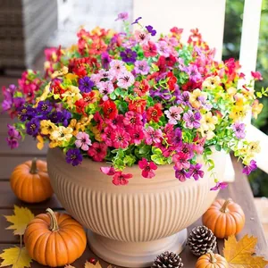 Outdoor autumn decor featuring colorful artificial morning glory flowers in a beige pot