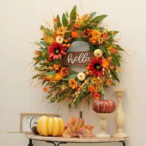 Autumn harvest wreath featuring sunflowers, white pumpkins, and a hello wooden sign