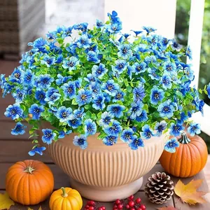 Blue artificial morning glory and eucalyptus in a ceramic pot for autumn outdoor decor