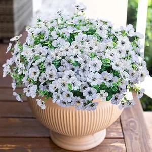 Detailed view of artificial purple morning glory flowers in a ribbed beige ceramic pot