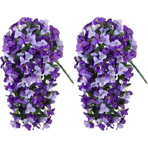 Detailed view of two faux purple bougainvillea hanging plants with silk petals and green leaves