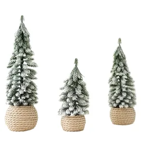 Mini flocked cedar Christmas trees with snow effect and burlap wrapped base for desk