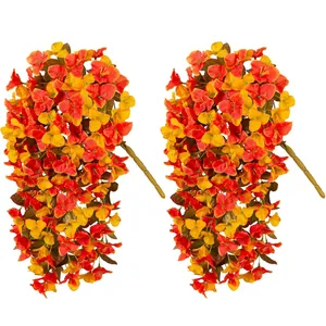 Detailed view of two dense bundles of artificial bougainvillea with red and orange flowers