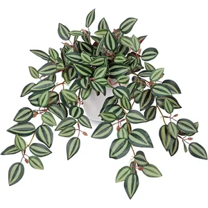 Detailed view of artificial Peperomia plant with striped leaves in a white ceramic pot