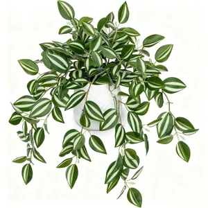 Close-up of realistic artificial greenery with striped leaves in a white ceramic pot