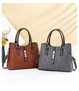 Detail view of the brown and grey handbags with luxury rectangular embossed texture