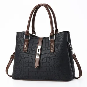 Elegant black faux-crocodile leather handbag with brown handles and silver clasp lock