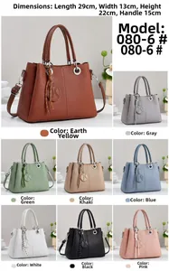 Close-up of geometric embossed handbag showing metal ring tassel and various color options